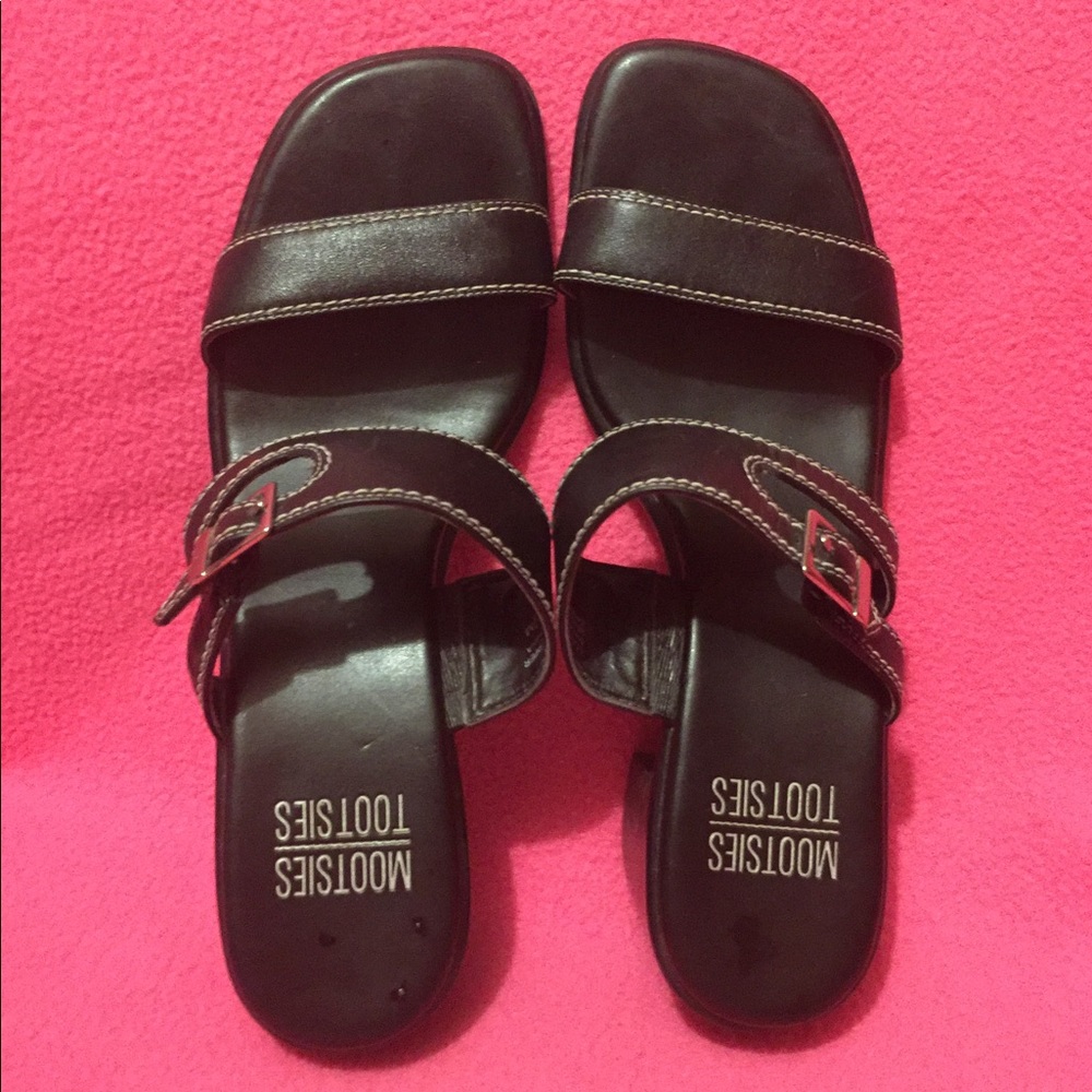 Black leather sandals with silver buckle.